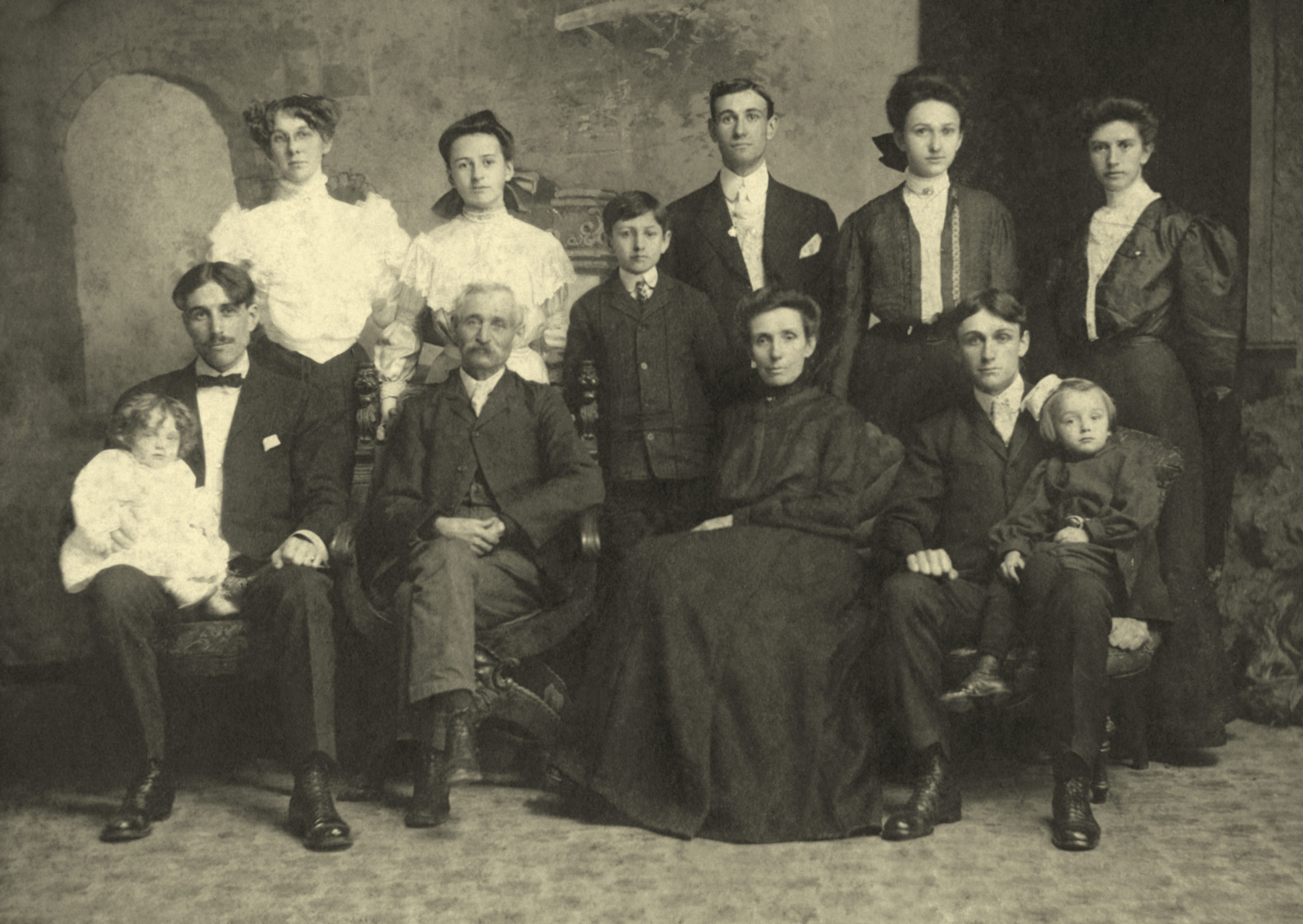 Back: Clara Galvin Sheldon (Sam's wife), Mary Elizabeth (youngest daughter of Harvey and Mary), Harold Horton (youngest son), Burt, Sarah Maude (Sadie), Anna Champion (LD's wife) Seated: Samuel Sheldon holding daughter Thelma, Harvey (father of the family), Mary Christian (mother), LD holding son, Harold