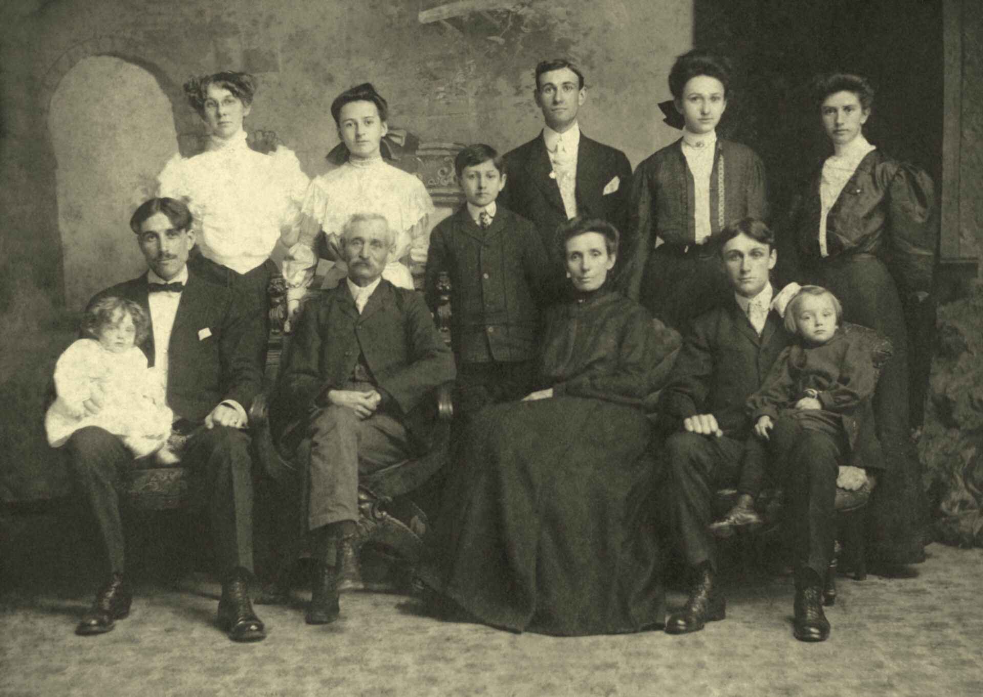 Harvey Sheldon and Mary Christian with children and spouses restored in 2015 – Copy Back: Clara Galvin Sheldon (Sam's wife), Mary Elizabeth (youngest daughter of Harvey and Mary), Harold Horton (youngest son), Burt, Sarah Maude (Sadie), Anna Champion (LD's wife) Seated: Samuel Sheldon holding daughter Thelma, Harvey (father of the family), Mary Christian (mother), LD holding son, Harold